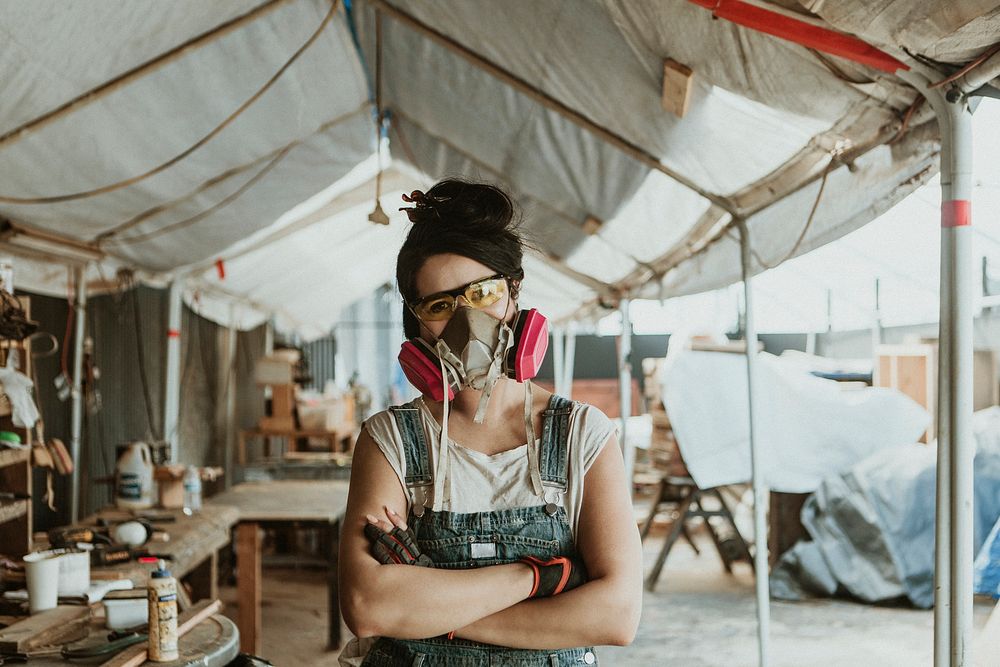 Female carpenter with personal protective equipment