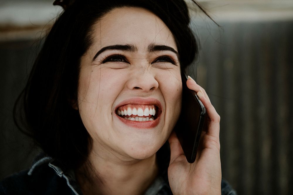 Cheerful female carpenter talking on a phone