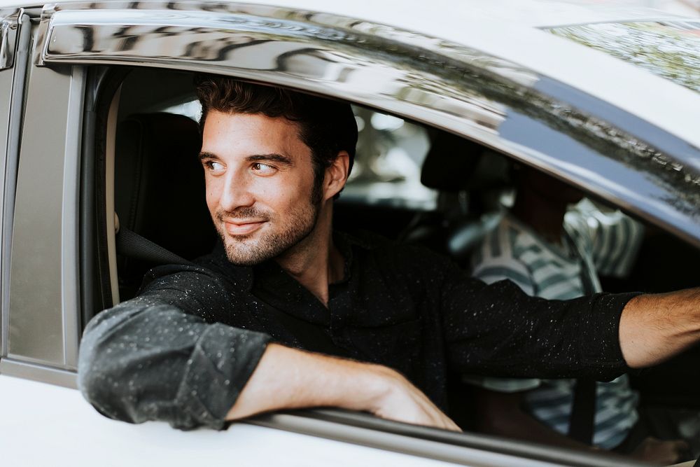 Handsome male driver sitting in a car