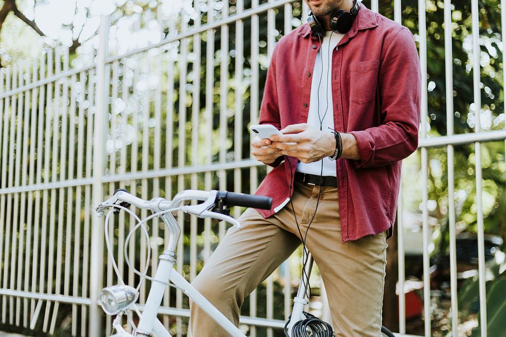 Caucasian man texting while sitting on the bike