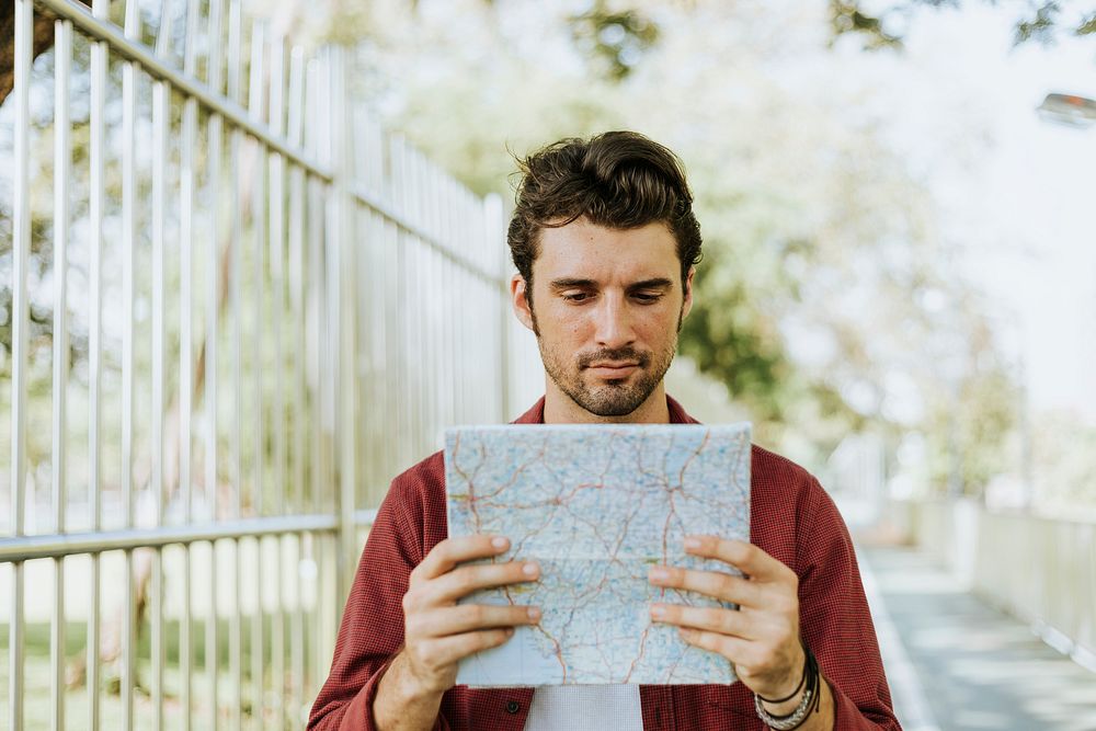 Man using a map in downtown park