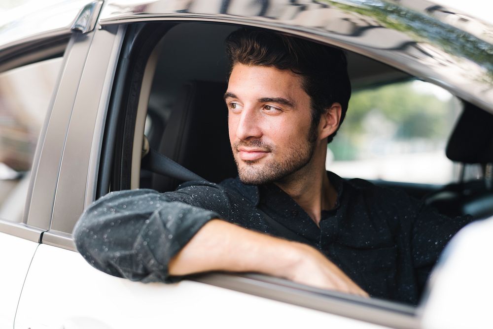 Handsome male driver sitting in a car