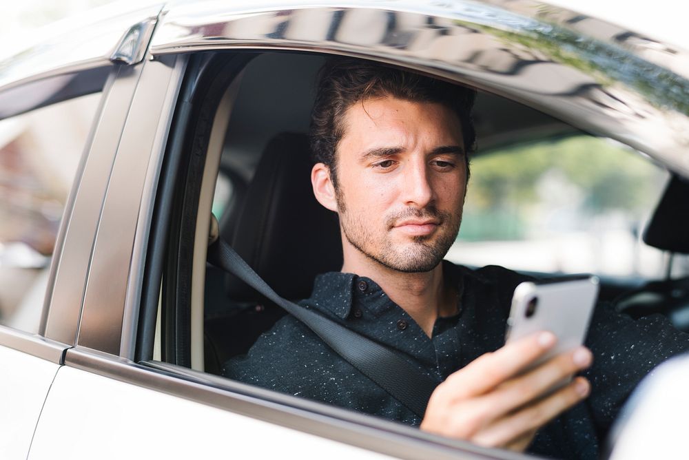 Man texting in his car