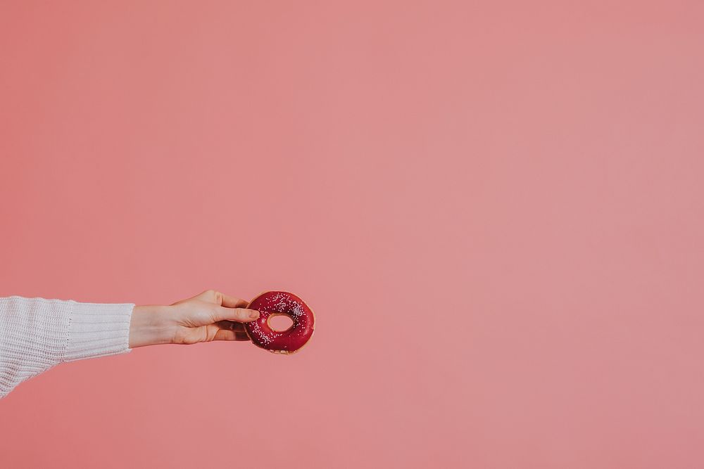 Woman holding a glazed donut