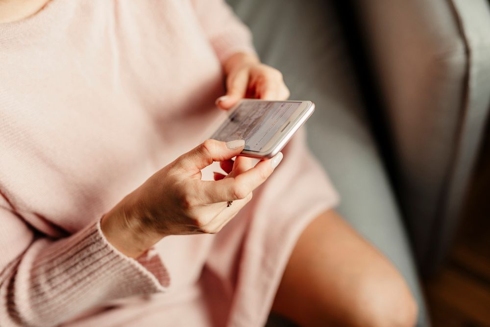 Woman scrolling through social media on a mobile phone