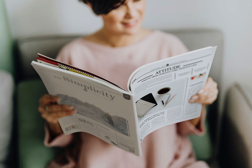 Happy woman reading a magazine