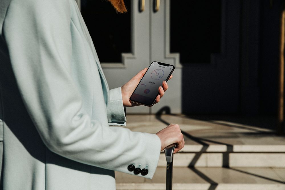 Female traveler using her phone on a street