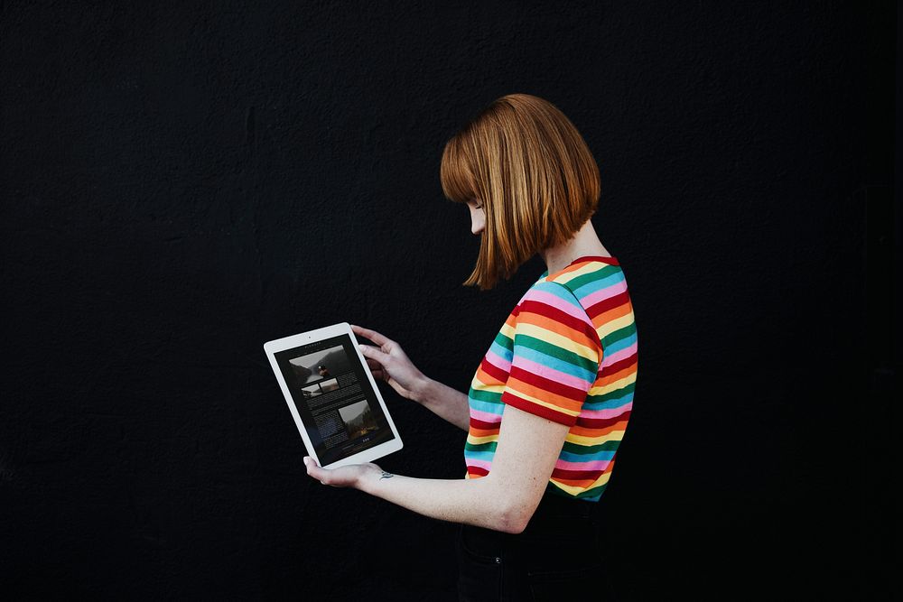 Woman using a digital tablet mockup in black background
