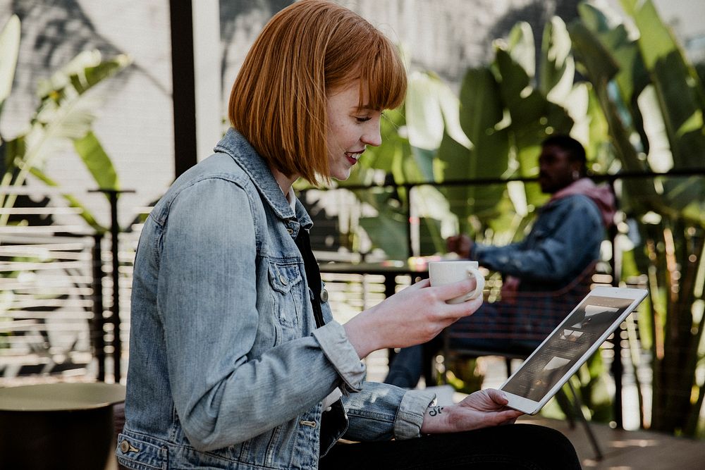 Woman using a digital tablet in a cafe