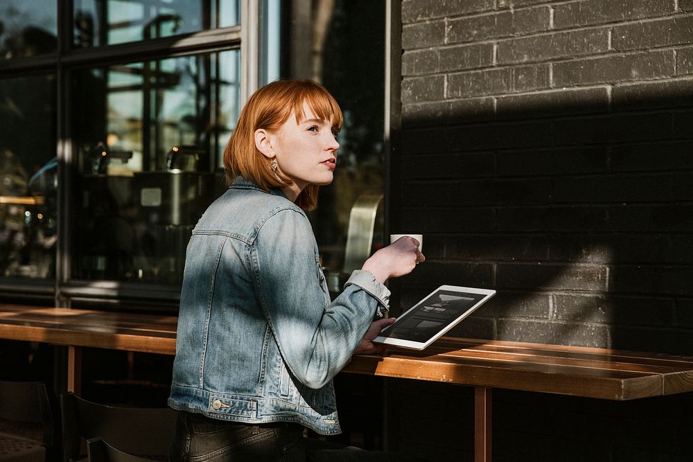 Woman using a digital tablet in a cafe