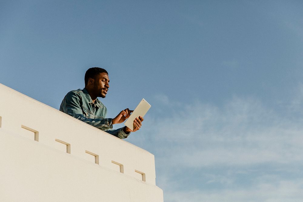 Man capturing the view of Los Angeles city with his tablet at the Griffith Observatory, USA