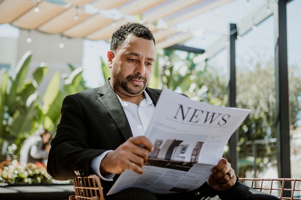 Businessman reading a newspaper in a cafe