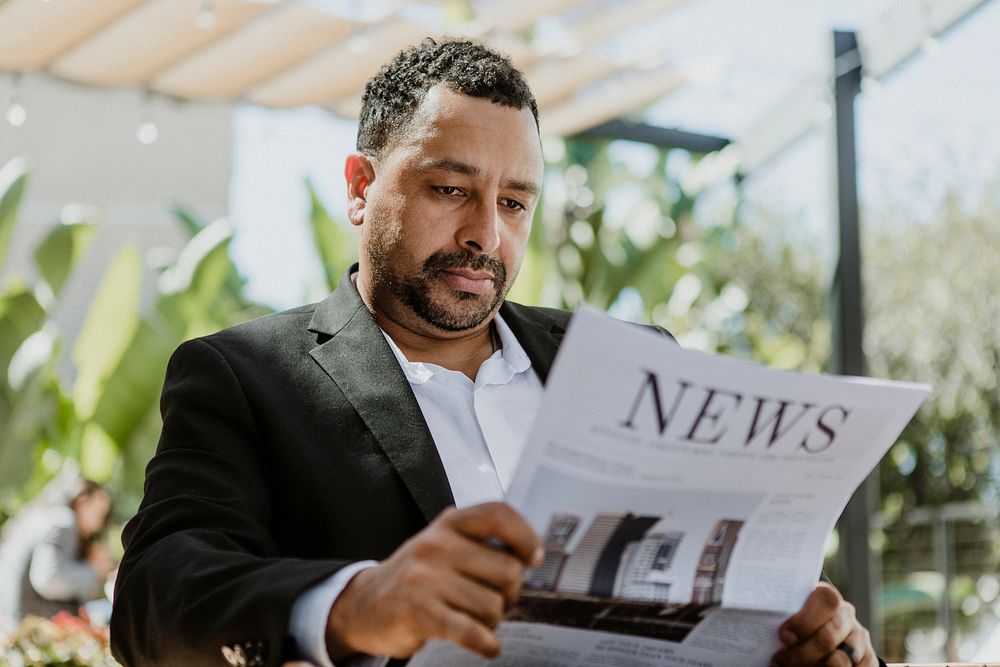 Businessman reading a newspaper in a cafe