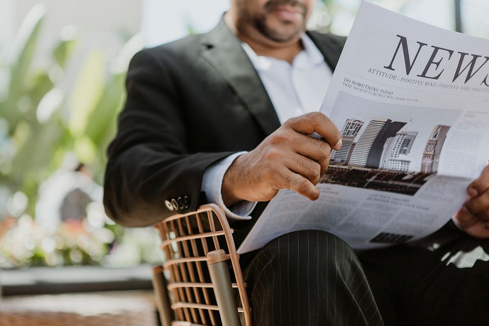 Businessman reading newspaper cafe | Free Photo - rawpixel