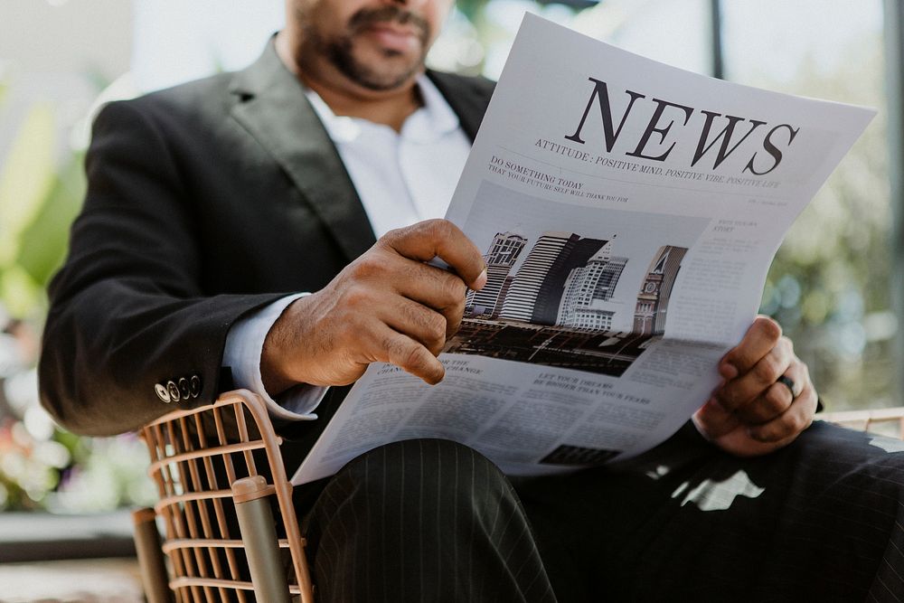 Businessman reading a newspaper in a cafe