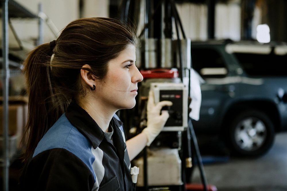 Female mechanic holding a switch in the garage