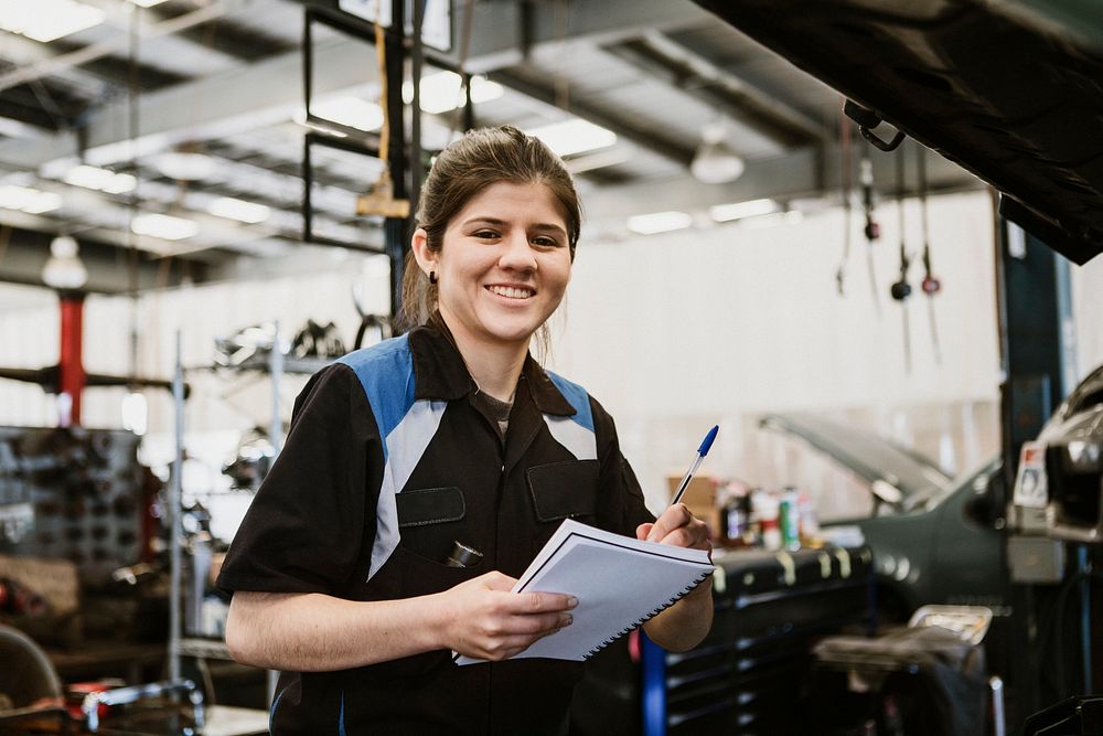 Female mechanic with a notebook