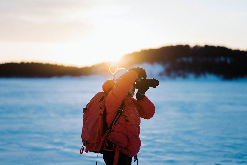 Photographer with a backpack enjoying the sunrise
