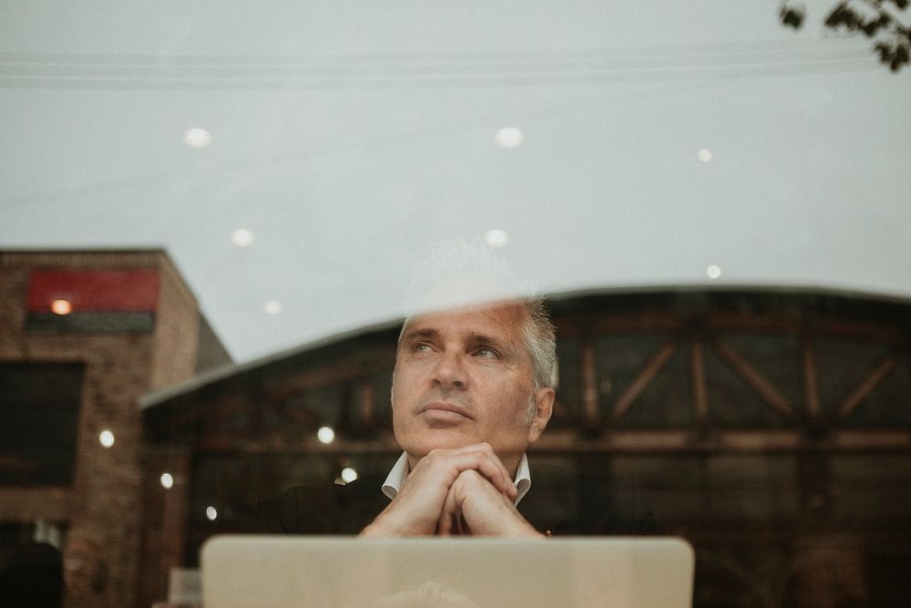 Thoughtful entrepreneur in a cafe