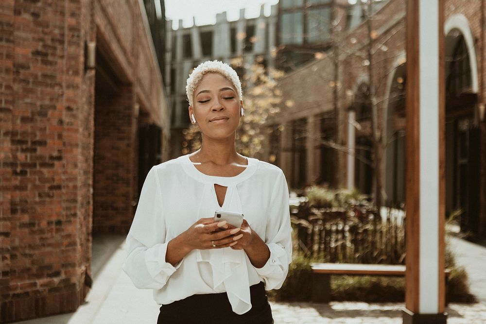 Happy black woman using her phone