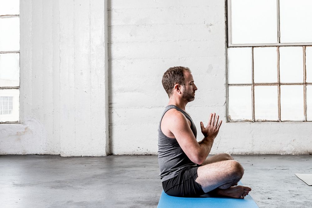 Yoga instructor teaching how to meditate to class