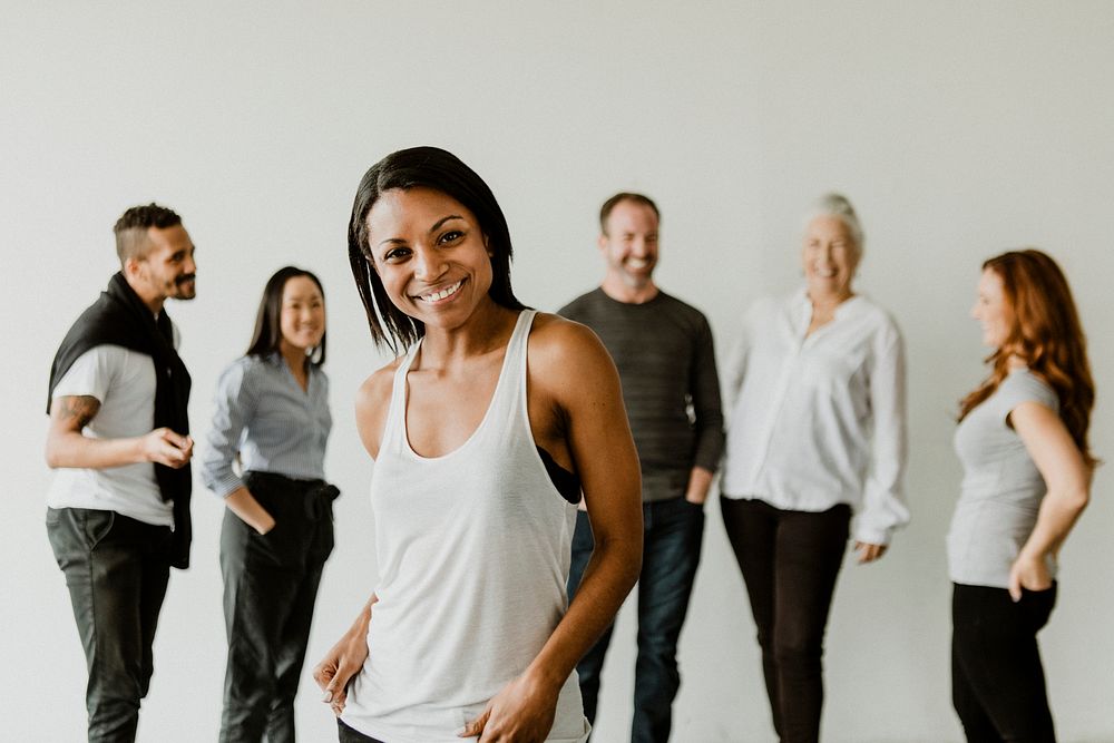 Confident black woman standing in front of her team