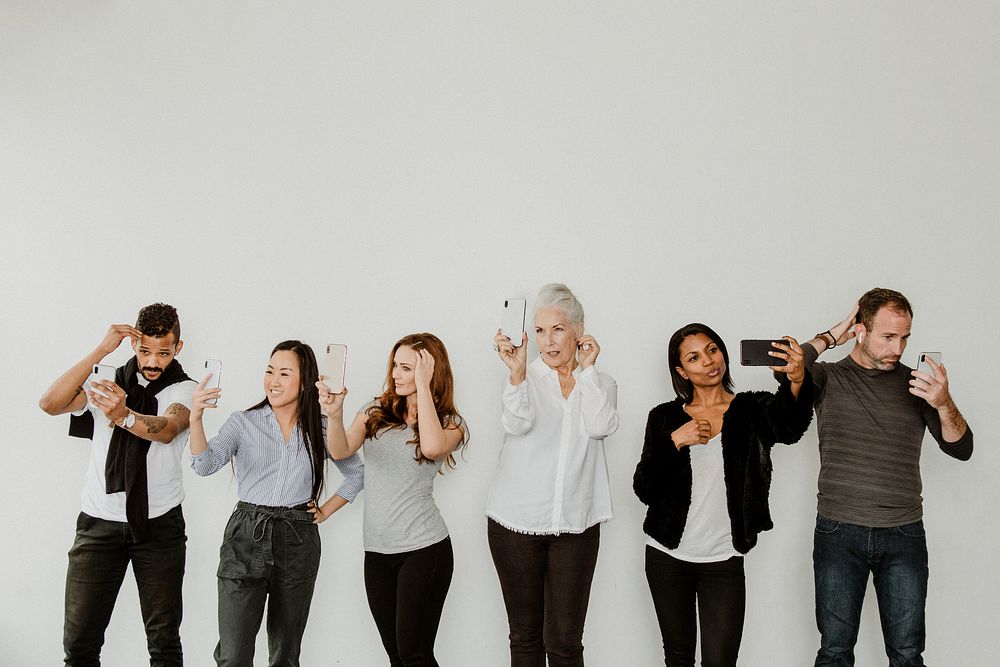 Diverse people taking a selfie of themselves with their phone