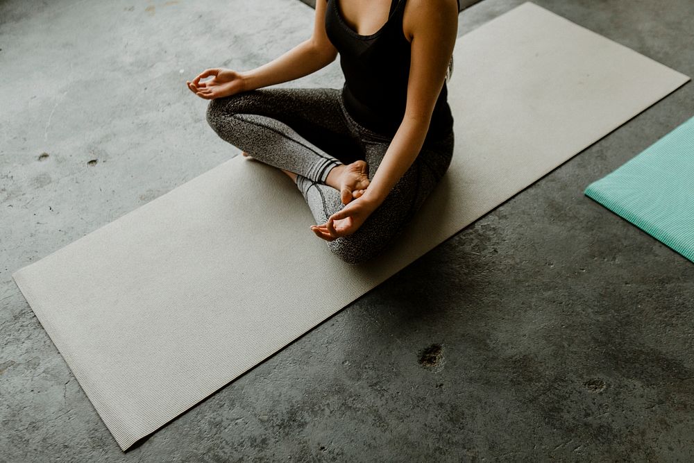 Woman meditating in a yoga class
