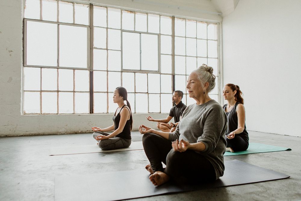 Diverse people meditating in a yoga class