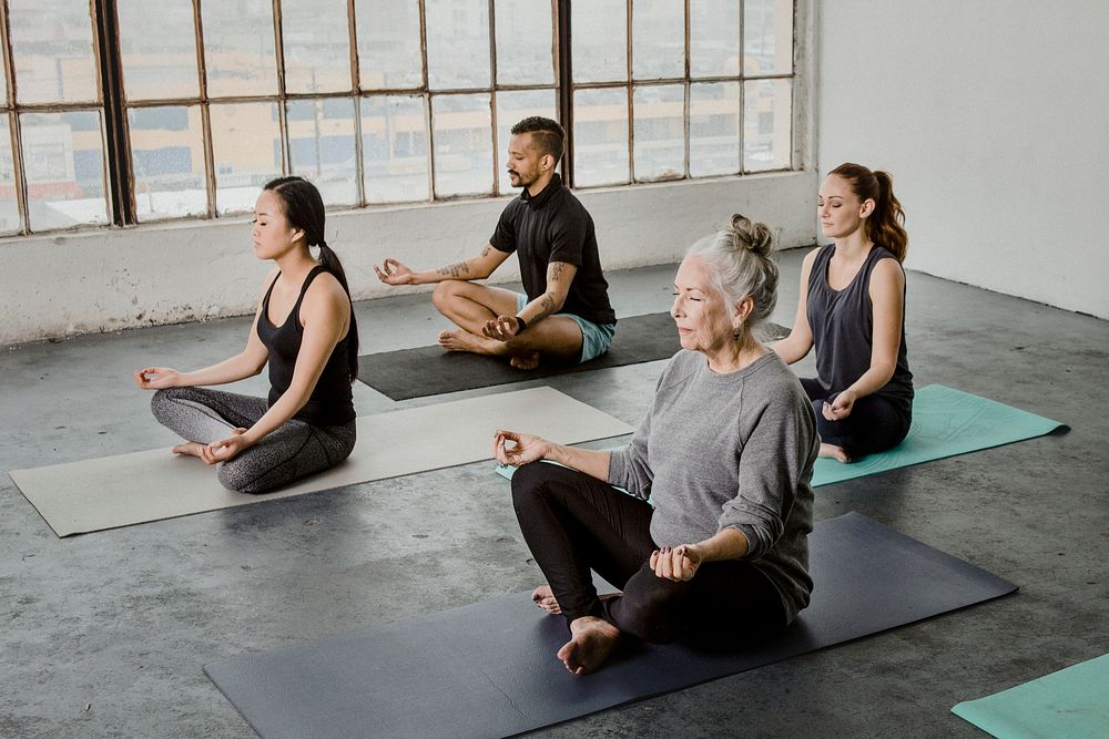 Diverse people meditating in a yoga class