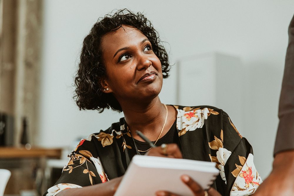 Businesswoman taking down notes in a meeting