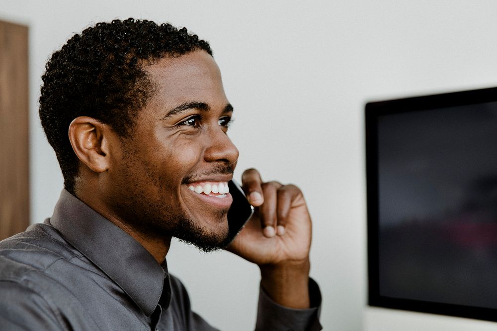 Happy black businessman talking on the phone