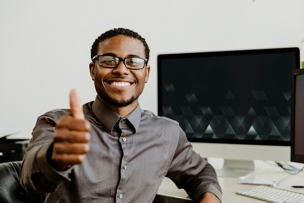 Happy black businessman doing a thumbs up