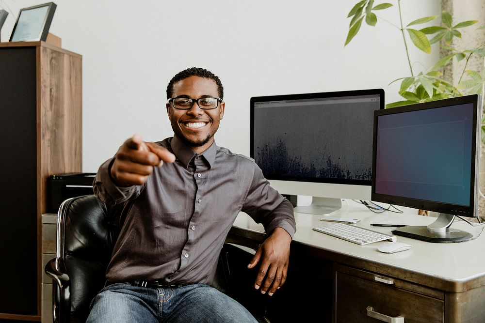 Happy black businessman pointing at the screen