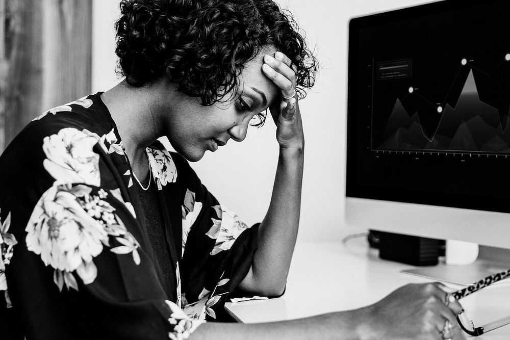 Stressed black businesswoman working in the office