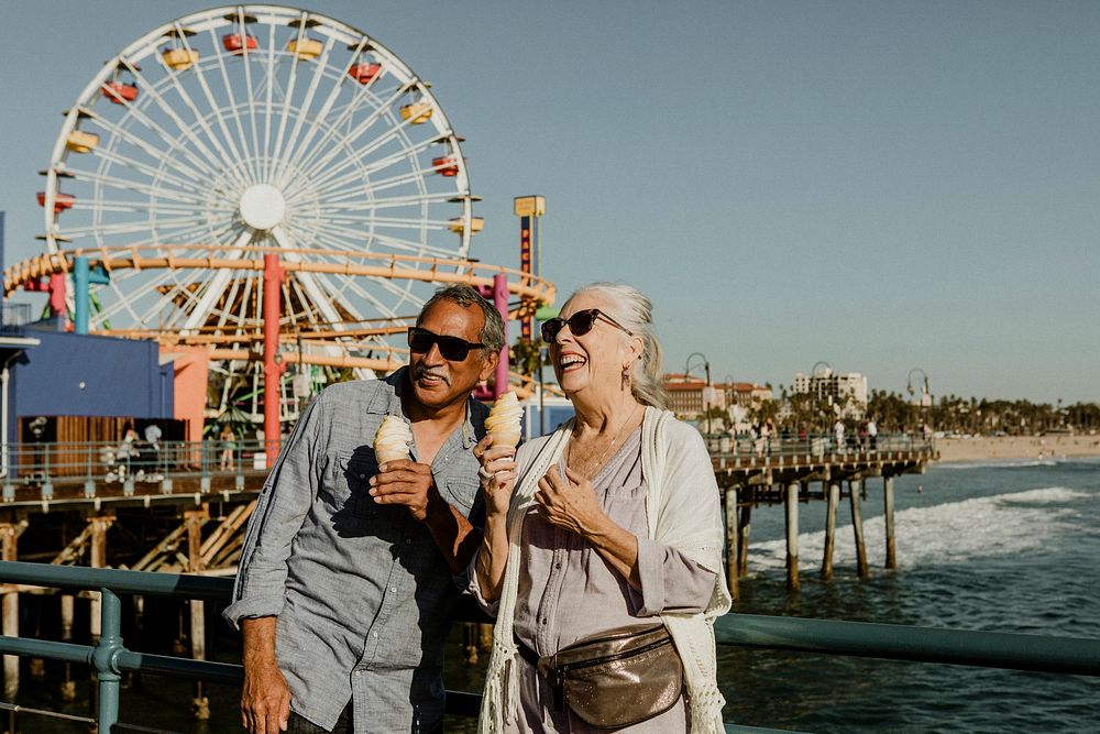 Smiling senior couple having ice cream at Santa Monica Pier