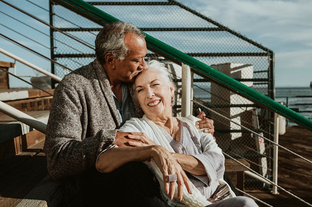 Happy romantic senior couple spending time together on the pier