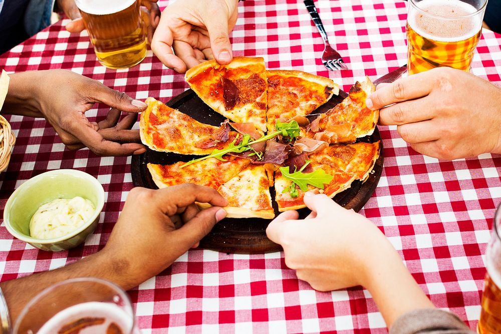 People sharing a pizza on the table