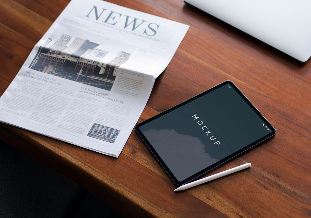Newspaper on a table with a digital tablet mockup