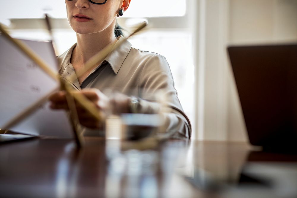 Businesswoman reading a business plan at her office