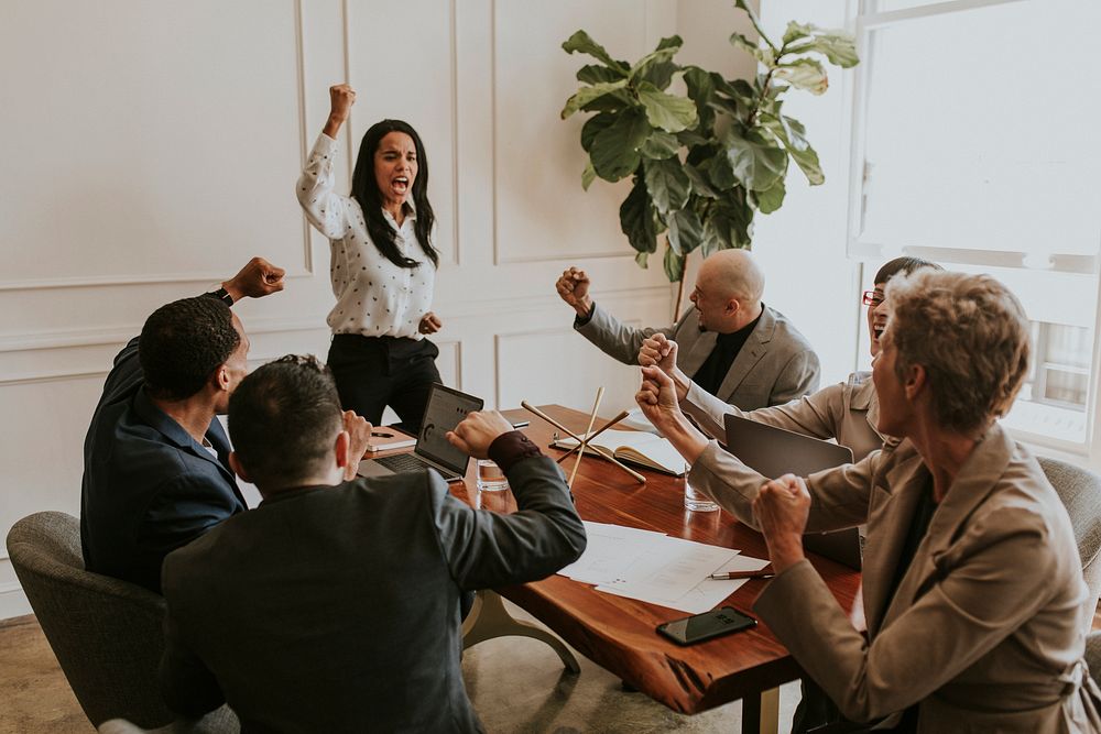 Businesswoman motivating her team members in a meeting