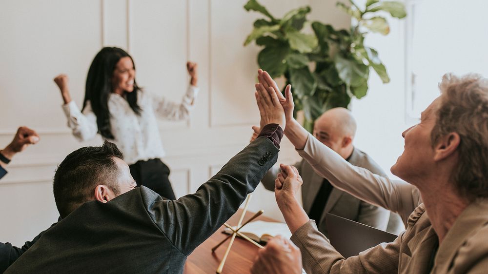 Successful business people doing a high five