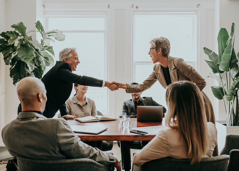 Happy diverse business people making a deal