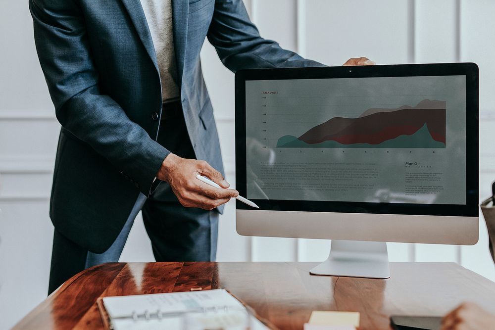 Businessman presenting a project on a computer desktop