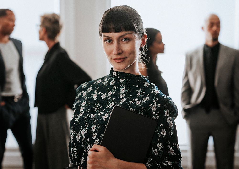 Confident businesswoman standing with a digital tablet