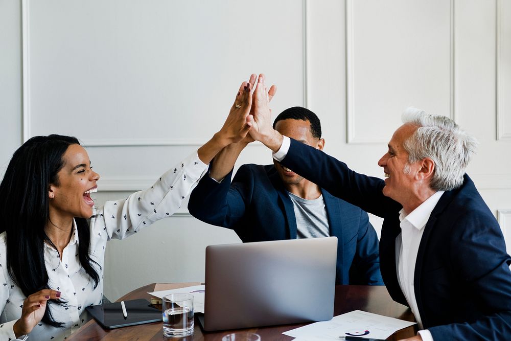 Successful business people doing a high five