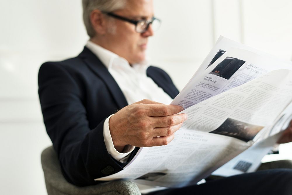 Senior businessman reading a newspaper