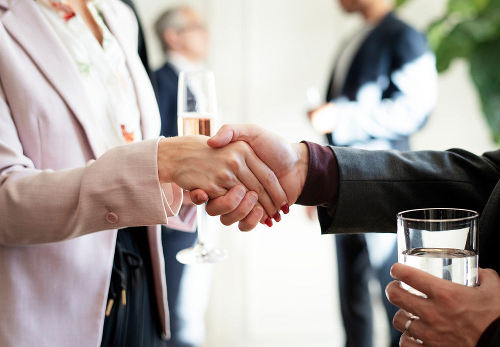 Business people shaking hands at an office party
