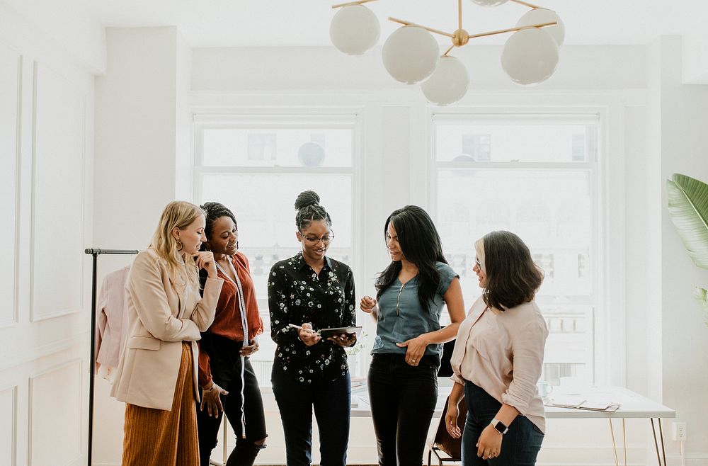 Happy female fashion designers working together