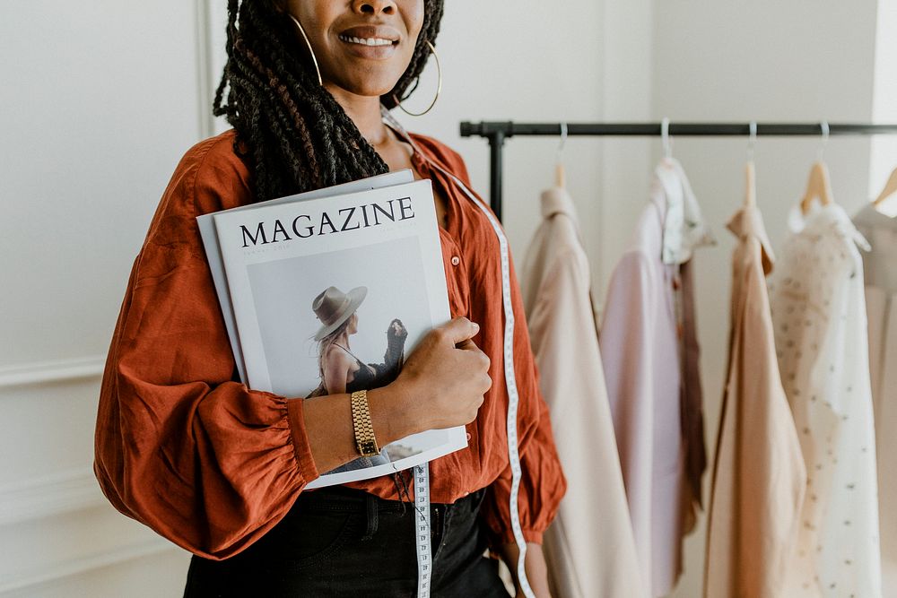 Young female designer holding a fashion magazine